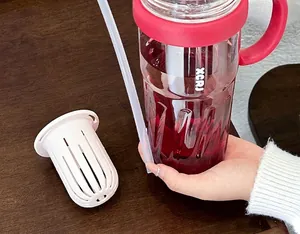 Close-up showing the detachable tea infuser and large capacity red water bottle