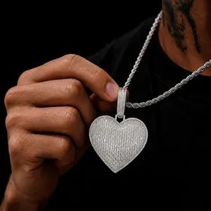 Detail of iced-out heart pendant necklace with sparkling baguette cubic zirconias