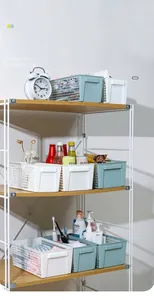 Detailed view of hollow rectangular plastic storage baskets organized on a metal shelf