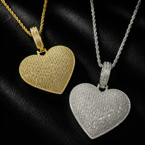 Detailed macro shot of hip-hop heart pendants in gold and silver with baguette CZ stones