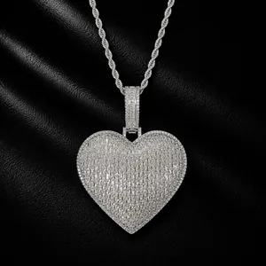 Close-up detail of iced out baguette zircon heart pendant on a silver rope chain