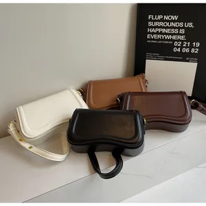 Detailed view of minimalist women's underarm shoulder bags in multiple colors