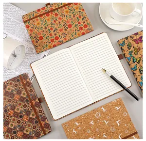 Top view of eco-friendly cork notebooks with bohemian patterns and lined pages.