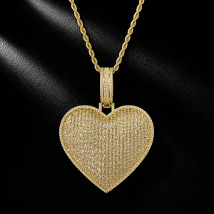 Close-up of gold iced out heart pendant necklace with baguette cubic zirconia stones