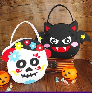 Macro detail view of Halloween non-woven felt gift bags featuring skull and bat designs.