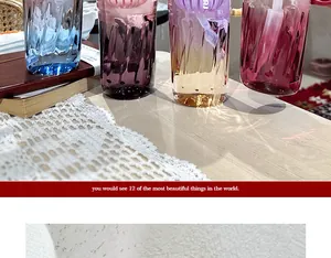 Detail view of colorful fluted glass cups with elegant gradient finishes on a table.