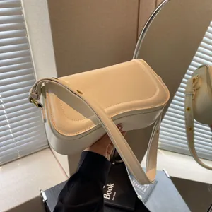 Minimalist cream underarm shoulder bag with elegant curved stitching detail