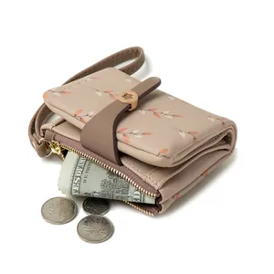 Elegant floral print bifold wallet for women with wrist strap and gold buckle closure