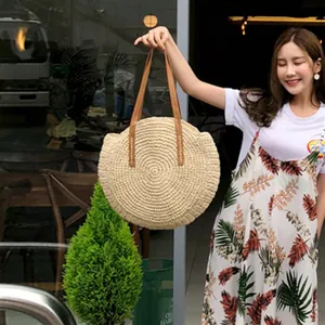 Stylish round straw woven shoulder bag for women perfect for summer beach trips