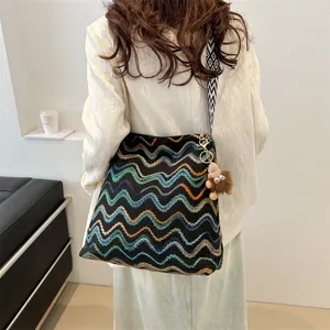 Large capacity knit bucket bag with colorful wave pattern and wide geometric strap