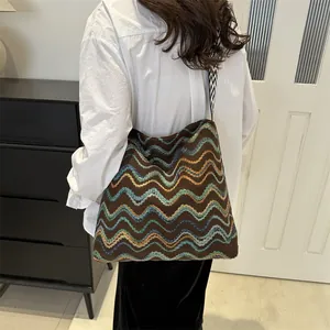 Bohemian style large knit shoulder bag with colorful wave patterns and geometric wide strap