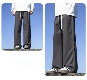 Close-up of men's dark gray straight wide-leg trousers in a soft cotton fabric
