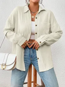 Detailed texture of women's cream long sleeve dropped shoulder shirt with buttons