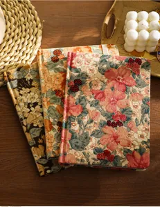 Close-up of three vintage A5 journals featuring unique floral corduroy fabric covers