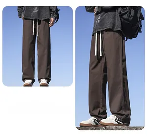 Two-angle view of men's loose straight-leg cotton casual trousers in brown