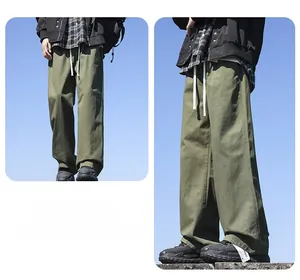 Detailed view showing the loose fit of men's olive green wide-leg cotton pants