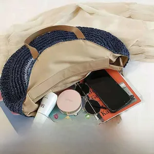 Λεπτομερής προβολή εσωτερικής χωρητικότητας γαλάζιας στρογγυλής ψάθινης τσάντας