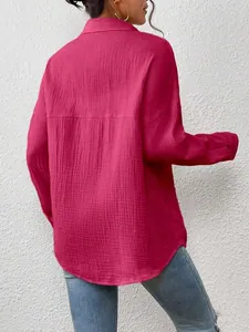 Back view of vibrant fuchsia pink long sleeve shirt with textured fabric and dropped shoulders