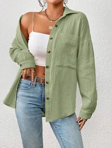 Detailed view of a sage green cotton gauze shirt featuring a large front pocket