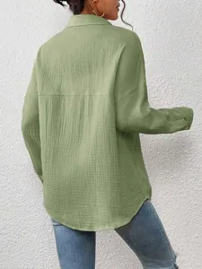 Back view of sage green dropped shoulder long sleeve shirt showing crinkled texture.