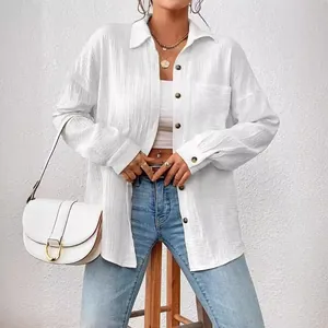 Elegant white textured long-sleeve blouse featuring drop shoulder and batwing sleeves design