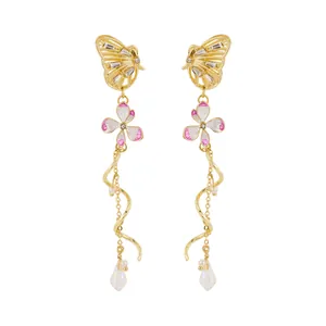 Elegant gold butterfly earrings detail featuring pink flowers and long spiral crystal tassels
