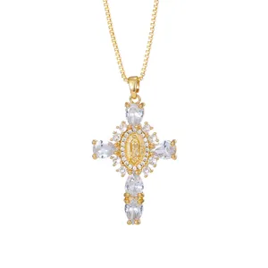 Macro view of gold cross pendant necklace featuring clear teardrop cubic zirconia