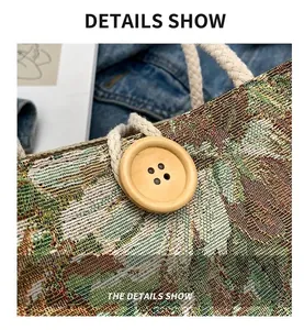 Detailed view of a wooden button and rope handle on a floral woven tapestry bag.
