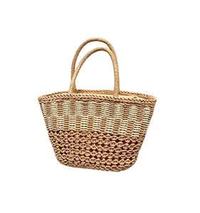 Close-up of handmade woven straw tote bag featuring detailed beach vacation style