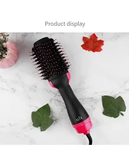 Detail view of professional 2-in-1 hot air styler brush with pink accents on marble.