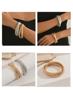 Bold gold and silver coiled snake bone necklace and bracelet set for women.