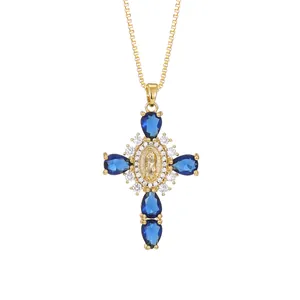 Vintage gold cross pendant necklace featuring blue pear-shaped cubic zirconia stones