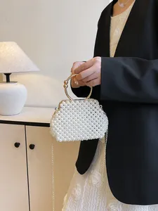 Elegant handmade woven pearl handbag with gold ring handle and chain strap for bridal use.