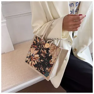 Detail view of a women's floral mini tote bag with rope handles and button closure