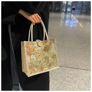 Close-up of vintage floral woven handbag with rope handles and wooden button