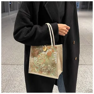 Close-up of floral print jute tote bag with rope handles and button closure