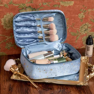 High-capacity blue flannel makeup bag featuring a gold starry sky pattern and brush slots
