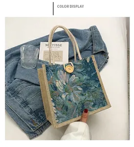 Elegant blue floral jacquard tote bag with woven handles and natural wooden button detail