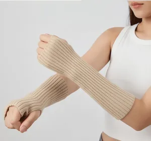 Close-up of long ribbed knitted fingerless arm warmers in beige for cold weather.
