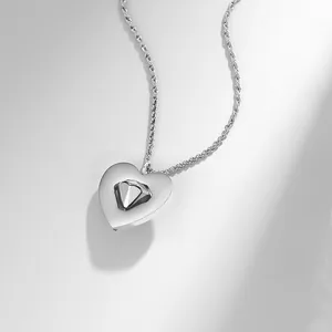 Macro view of rotating diamond element on a silver heart-shaped pendant necklace