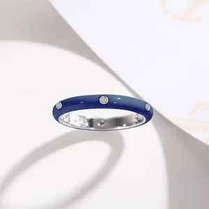 Detail view of a minimalist blue enamel ring featuring inlaid sparkling zircon stones.