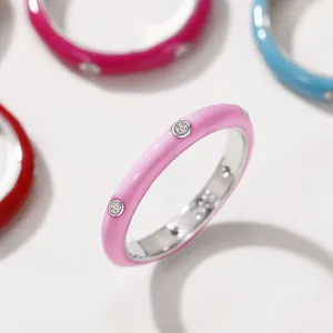 Detailed macro view of a minimalist pink enamel ring featuring sparkling zircon insets