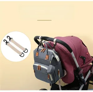 Diaper bag attached to stroller with detachable hanging clips for hands-free travel