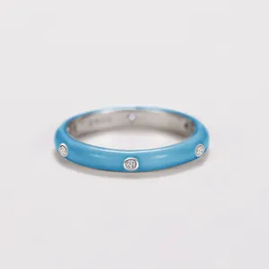 Macro view showing the blue enamel finish and inlaid zircons on this minimalist ring