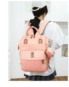 Stylish large capacity pink diaper bag backpack with quilted detail on model
