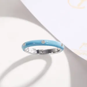 Detailed macro view of a minimalist light blue enamel ring featuring small zircon stones