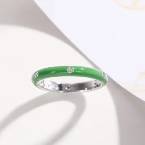 Detailed macro view of a minimalist green enamel ring decorated with sparkling zircons
