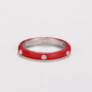 Detailed view of red enamel ring band with inlaid sparkling cubic zirconia stones