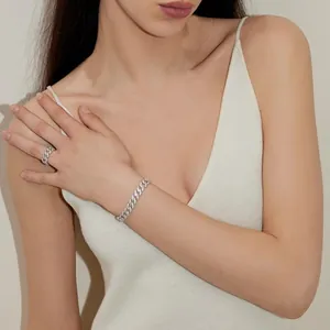 Elegant silver Cuban link jewelry set featuring a bracelet and ring with pave diamonds