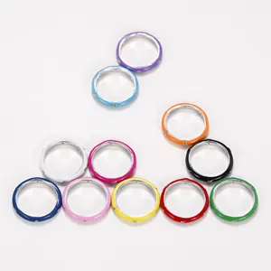 Minimalist colorful enamel rings set featuring rainbow zircon stones on white background